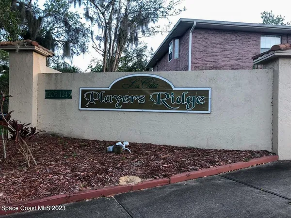 a front view of a house with parking area