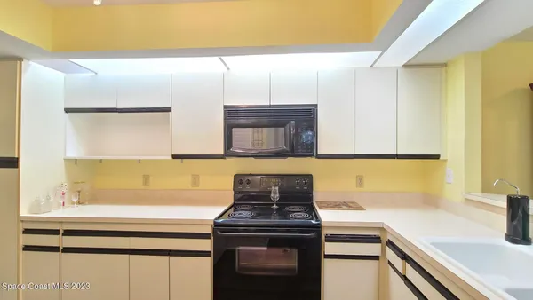 a kitchen with a sink and a stove top oven