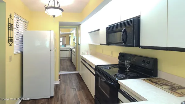 a kitchen with a stove and a refrigerator