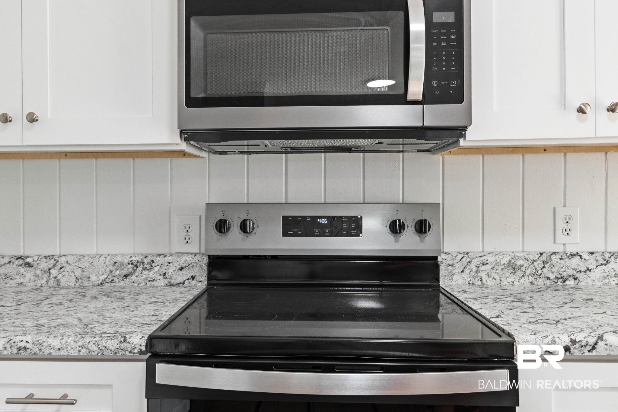 311 Cloverdale Road Atmore, AL 36502 - Photo 18 of 63 Stainless steel microwave and electric range with a flat cooktop