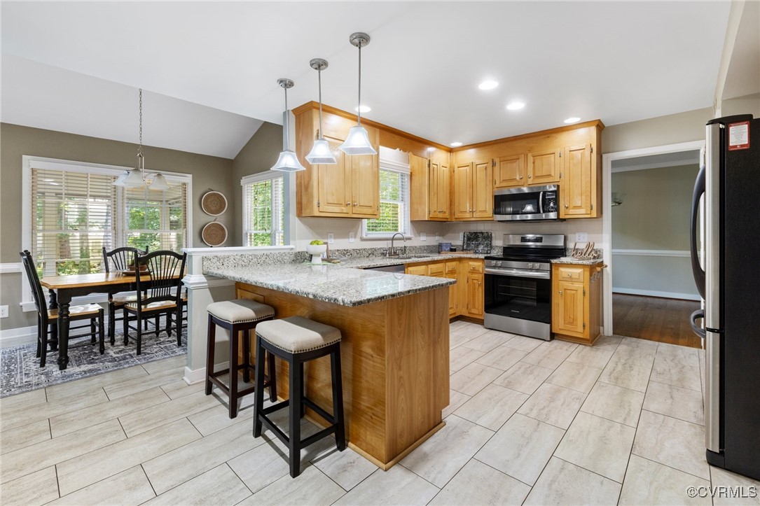 15210 Powell Grove Road Midlothian, VA 23112 - Photo 12 of 36 a kitchen with stainless steel appliances granite countertop a stove top oven a sink a dining table and chairs
