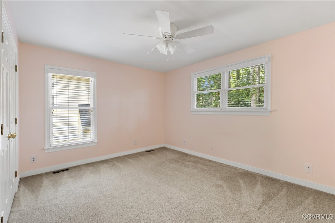 15210 Powell Grove Road Midlothian, VA 23112 - Photo 21 of 36 an empty room with a window and a ceiling fan