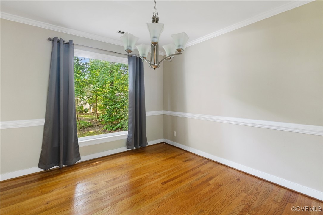 15210 Powell Grove Road Midlothian, VA 23112 - Photo 7 of 36 an empty room with wooden floor fan and windows