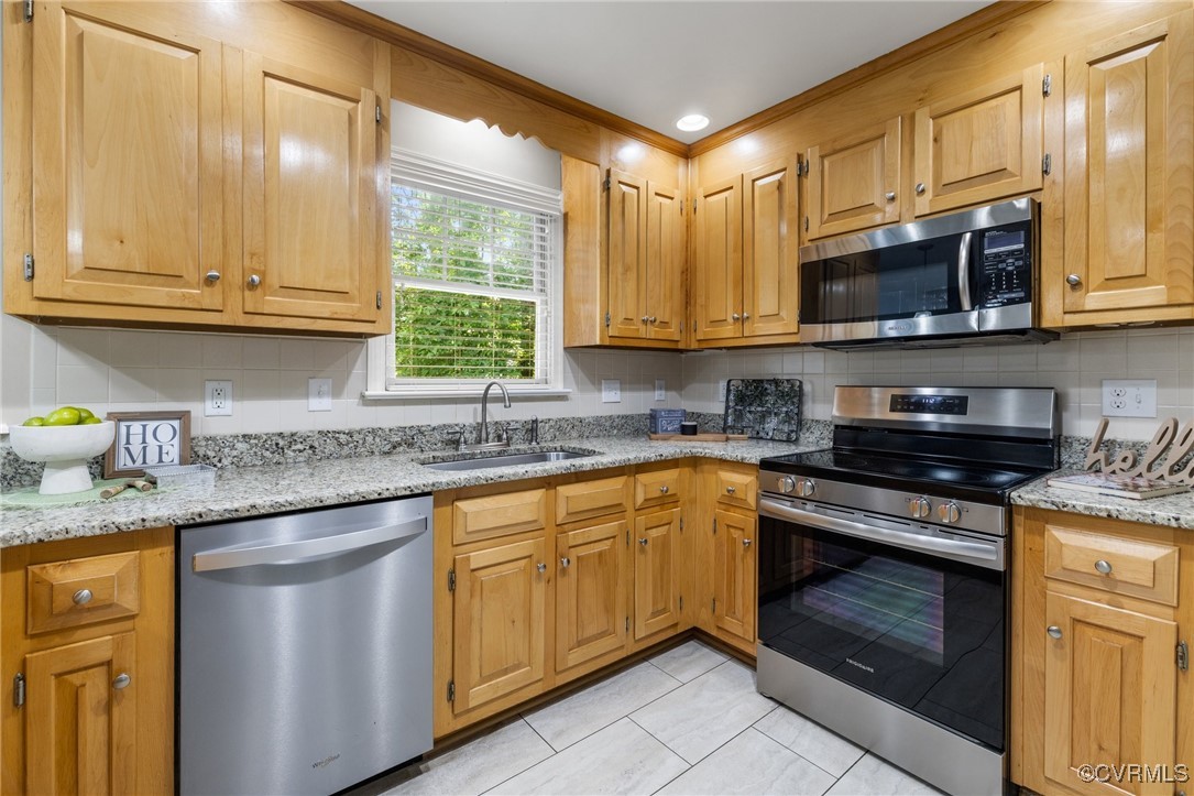 15210 Powell Grove Road Midlothian, VA 23112 - Photo 10 of 36 a kitchen with stainless steel appliances granite countertop a sink and a stove