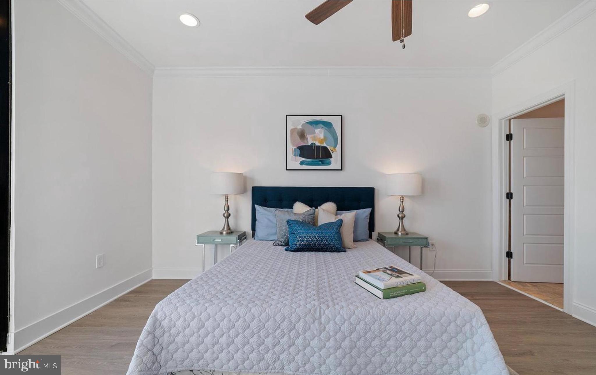 1 Brown Street, Unit 2B2BA Philadelphia, PA 19123 - Photo 19 of 29 a bedroom with a bed and a chandelier