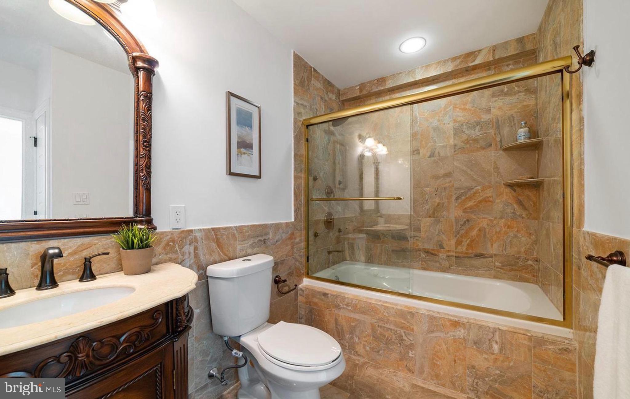 1 Brown Street, Unit 2B2BA Philadelphia, PA 19123 - Photo 22 of 29 a bathroom with a bathtub shower sink mirror and toilet