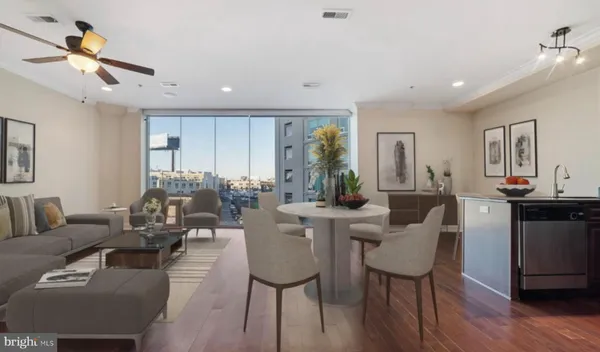 a living room with lots of furniture and kitchen view