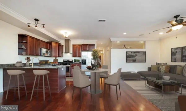 a living room with furniture and a chandelier