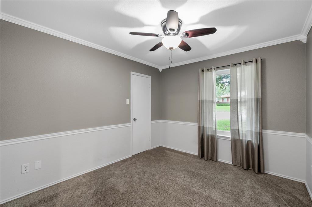 310 Ruth Drive Hewitt, TX 76643 - Photo 13 of 25 Carpeted room featuring two-tone wall treatment with wainscoting, crown molding, and a ceiling fan with light fixture