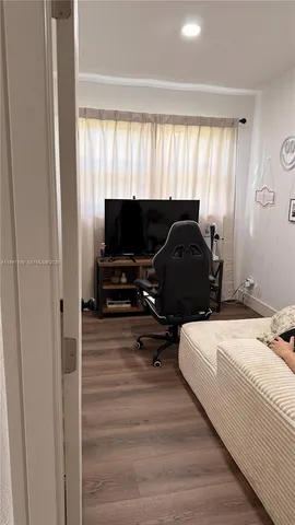 a bedroom with a bed and a television