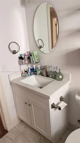 a bathroom with a sink mirror and toilet
