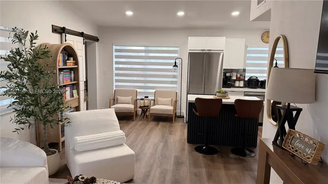 a living room with furniture and a potted plant