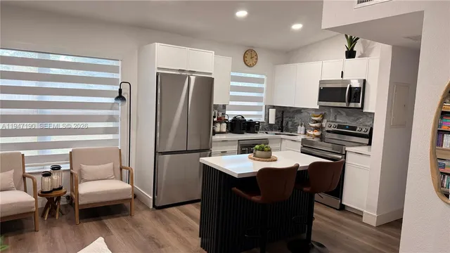 a kitchen with refrigerator and sink