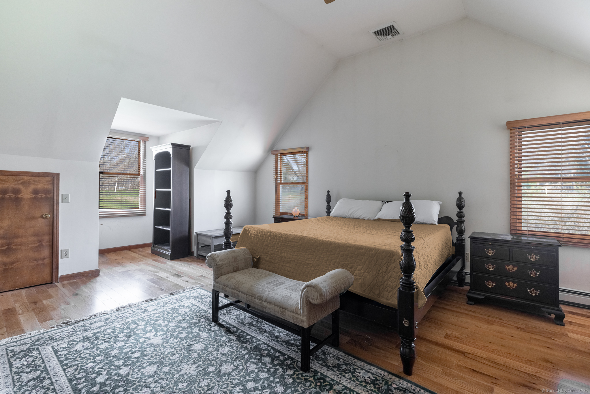 38 Barnhill Road Woodbury, CT 06798 - Photo 14 of 23 Oversized primary bedroom with oak flooring and a vaulted ceiling.