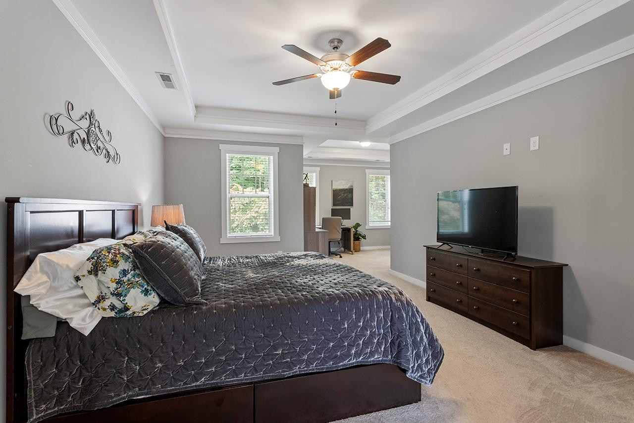3051 Freeman Farm Way Rolesville, NC 27571 - Photo 20 of 37 Tray ceiling and fan in the primary suite lead to a convenient sitting area/office and ensuite bath