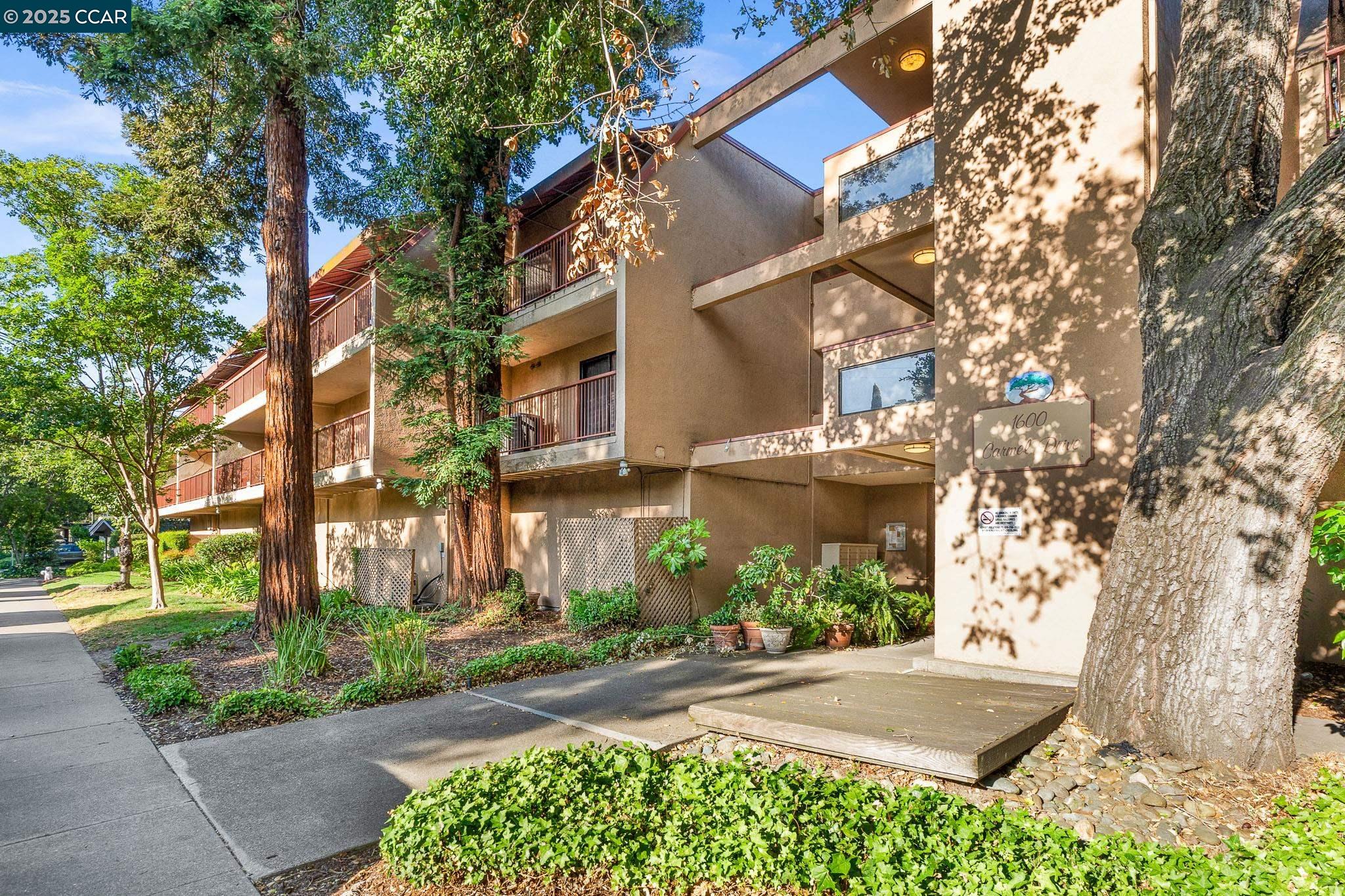 1600 Carmel Drive, Unit 15 Walnut Creek, CA 94596 - Photo 1 of 1 a view of a building with a yard