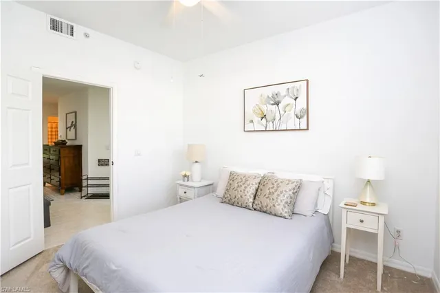 a bedroom with a bed and a painting on the wall