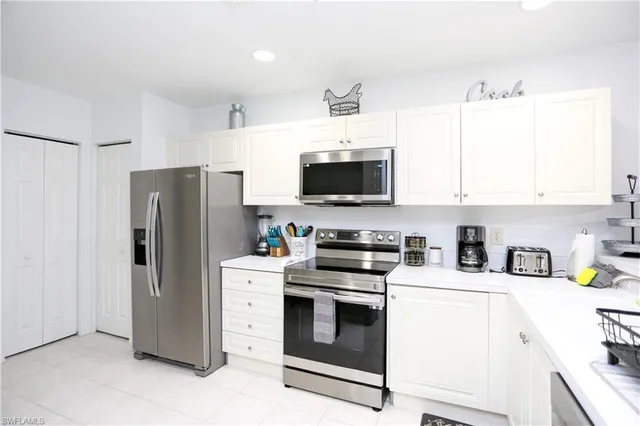 a kitchen with stainless steel appliances a refrigerator stove and microwave