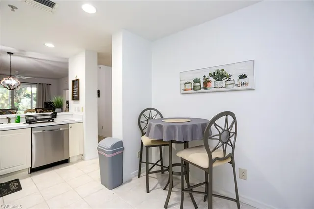 a view of a dining room with furniture and a chandelier