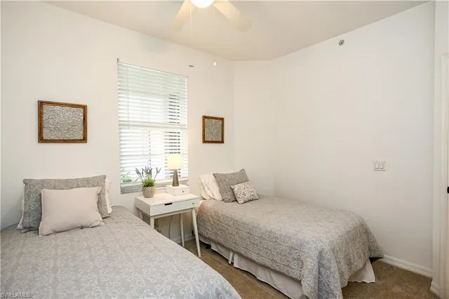 a bedroom with a bed and a lamp