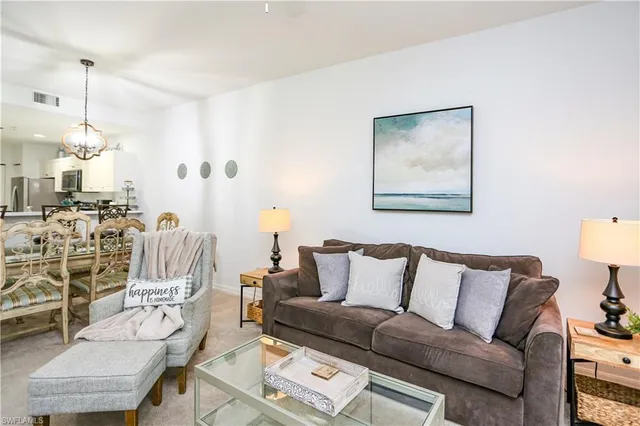 a living room with furniture a couch and a chandelier