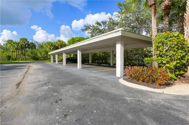 a view of a house with porch and garden