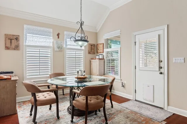 a view of a dining room with furniture window and wooden floor
