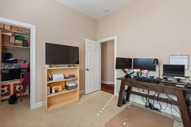a view of a workspace with furniture and a flat screen tv