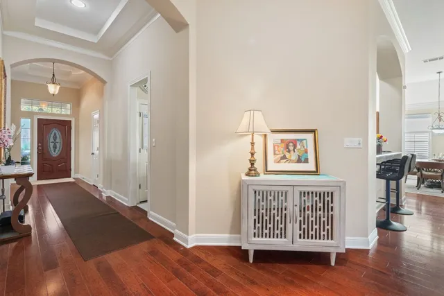wooden floor with a view of a hallway with wooden floor