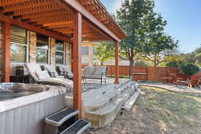 a front view of a house with swimming pool and furniture