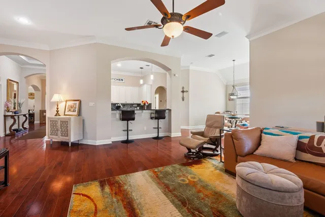 a living room with furniture and wooden floor
