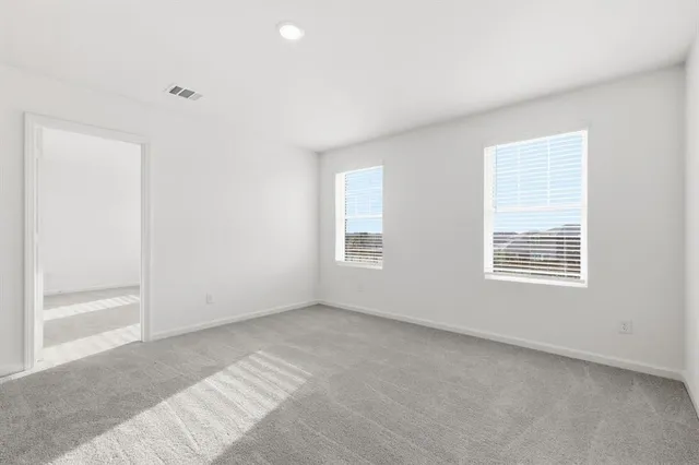 a view of a big room with closet and mirror