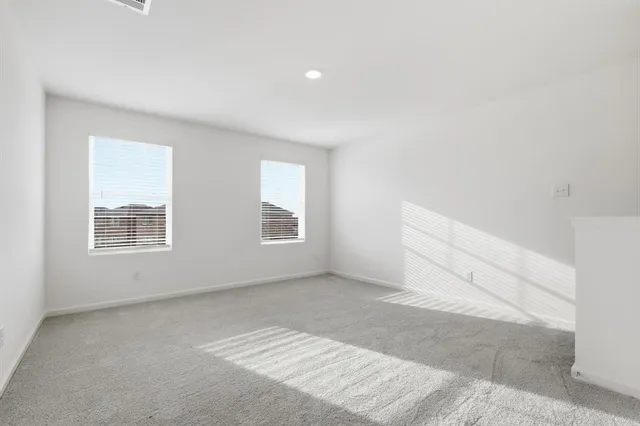 a view of a room with an empty space and kitchen view