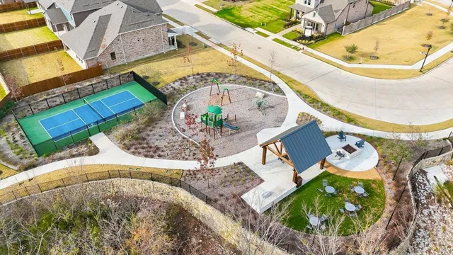a view of backyard with large windows and wooden fence