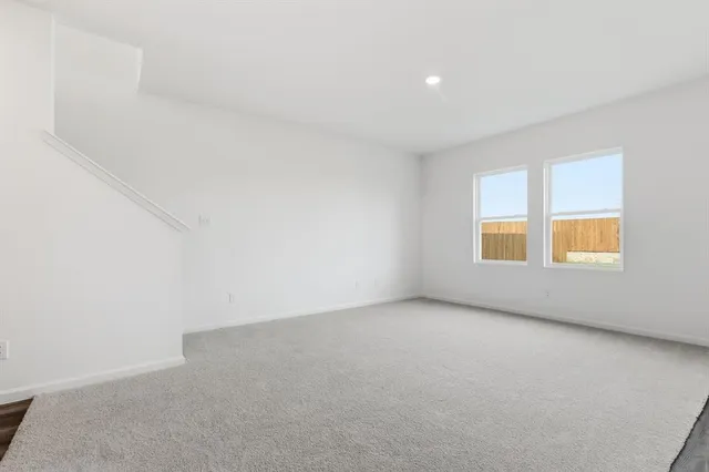 a view of kitchen with kitchen island white cabinets and refrigerator