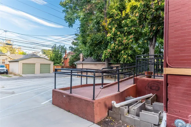 a view of a patio with couches table and chairs and potted plants