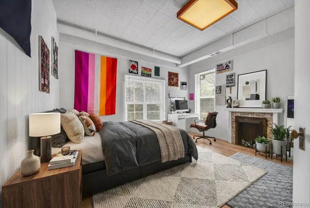 a bed room with a bed and a fireplace