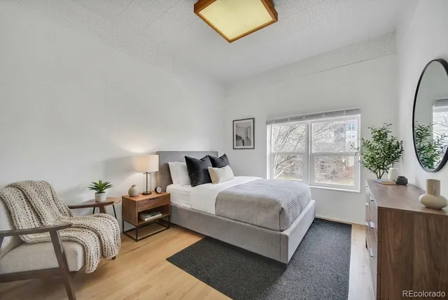 a bedroom with a bed a couch and dresser