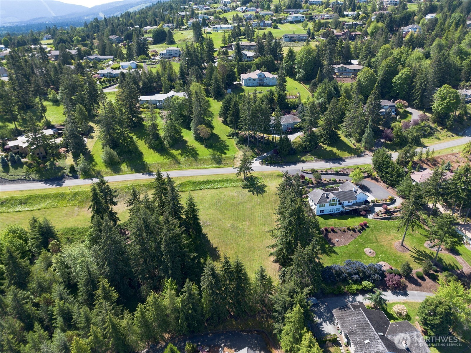 1 Owls Nest Road Sequim, WA 98382 - Photo 31 of 31 an aerial view of residential houses with outdoor space and trees