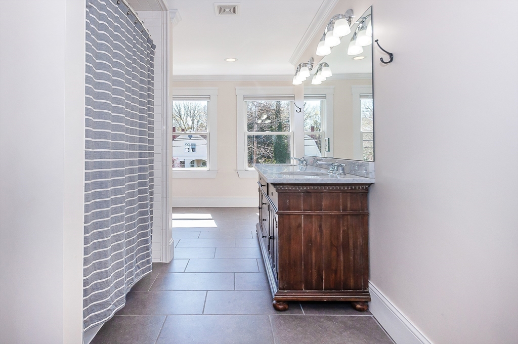 501 Point Road Marion, MA 02738 - Photo 29 of 42 a hallway with windows and a chandelier