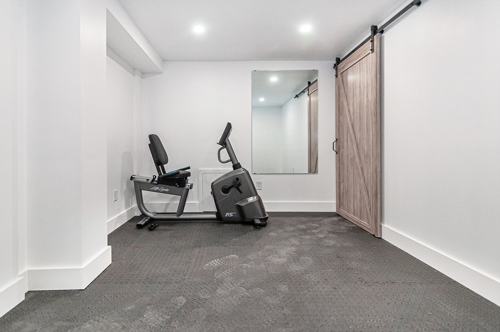 501 Point Road Marion, MA 02738 - Photo 36 of 42 a room with gym equipment and a flat screen tv
