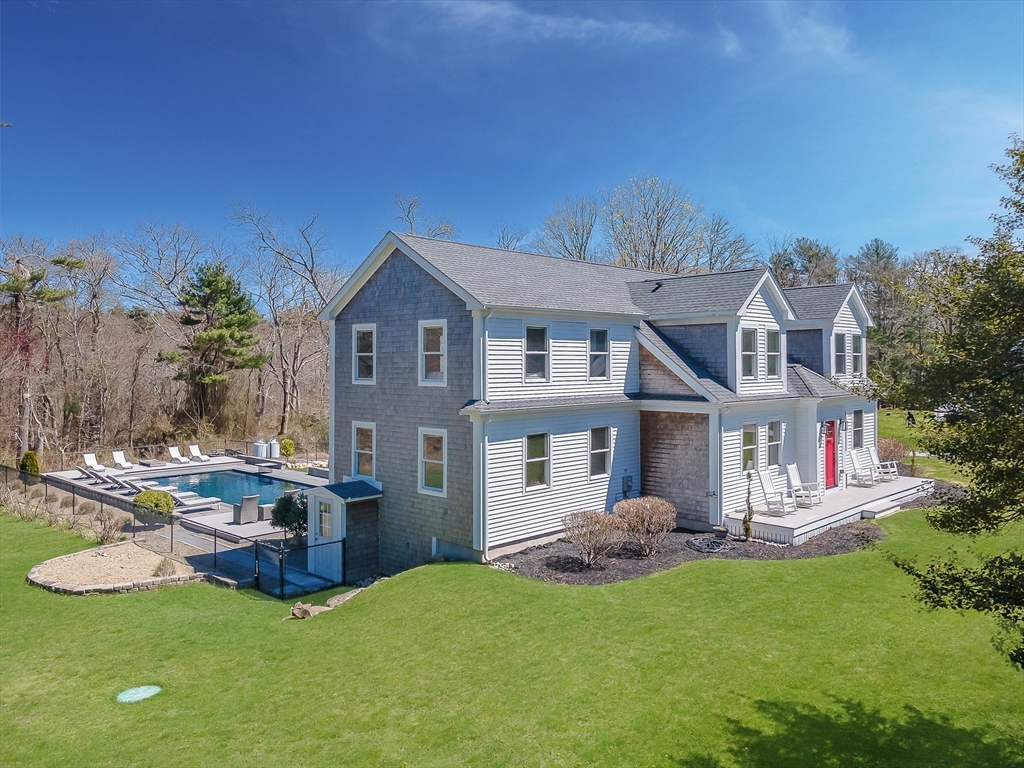 501 Point Road Marion, MA 02738 - Photo 5 of 42 a front view of a house with a garden and plants