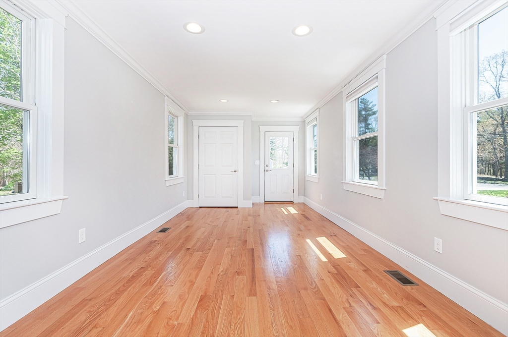 501 Point Road Marion, MA 02738 - Photo 9 of 42 an empty room with wooden floor and windows