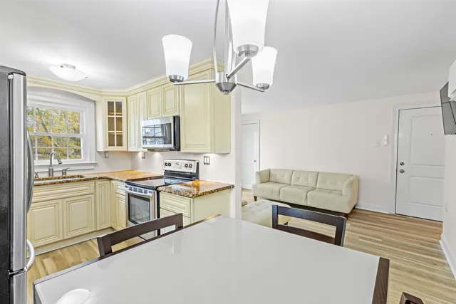 a living room with furniture and a chandelier