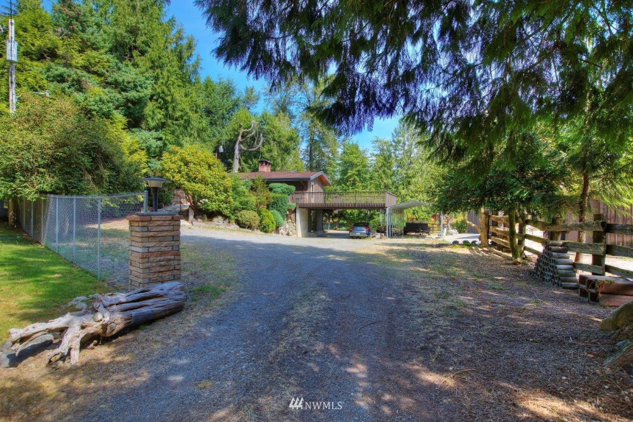 22004 Southeast Bain Road Renton, WA 98058 - Photo 1 of 27 a view of a street with a bench and trees