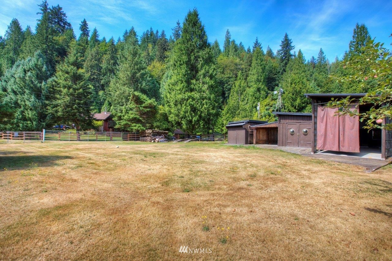 22004 Southeast Bain Road Renton, WA 98058 - Photo 22 of 27 a view of a backyard with large trees and wooden fence