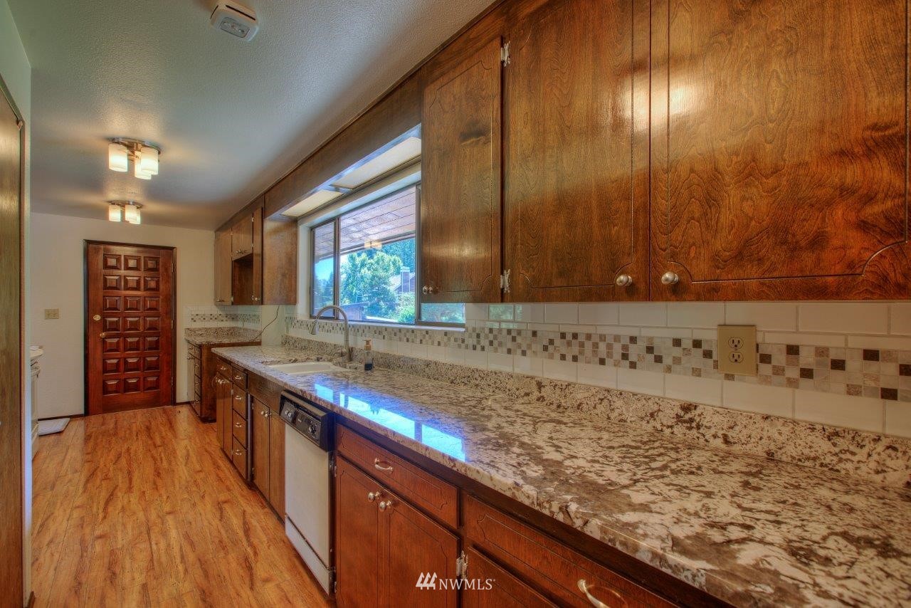 22004 Southeast Bain Road Renton, WA 98058 - Photo 9 of 27 a kitchen with a sink and cabinets