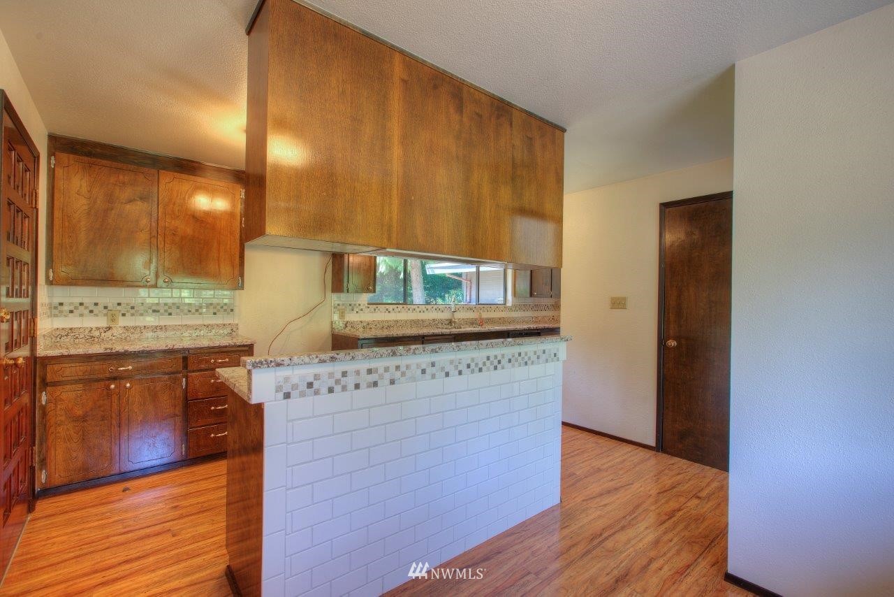 22004 Southeast Bain Road Renton, WA 98058 - Photo 10 of 27 a kitchen with stainless steel appliances granite countertop a coffee maker a sink and a refrigerator
