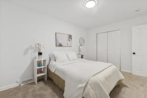 a bedroom with a bed and a lamp
