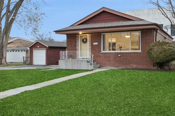 a front view of a house with a yard and porch
